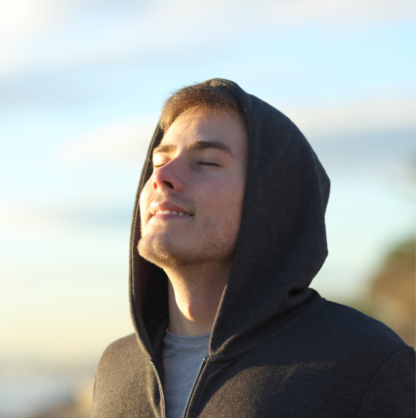 Teenage man breathing fresh air on the beach